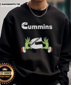 Alt Text: Awesome Grinch hands holding a Cummins Christmas sweatshirt, perfect for festive holiday celebrations.