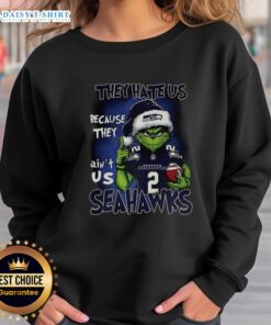 Awesome Grinch Santa Hat sweatshirt for Seattle Seahawks fans, featuring 'They Hate Us Because They Ain't Us' design.