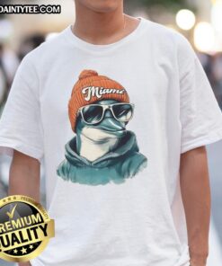 Alt Text: Awesome Miami Dolphins mascot in a beanie and sunglasses, showcasing team spirit on a trendy T-shirt.