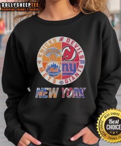 Alt Text: Awesome New York Knicks, Mets, Devils, and Giants mashup logo sweatshirt showcasing iconic NYC sports teams.