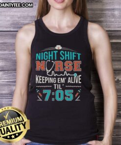 Night shift nurse in 'Keeping Em Alive Til 7:05' tank top providing care in a hospital setting during a night shift.