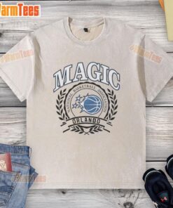 Alt Text: Retro washed t-shirt featuring the Orlando Magic NBA logo framed by a laurel wreath for basketball fans.