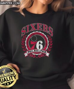 Alt Text: Retro sweatshirt featuring the Philadelphia 76ers NBA logo framed by a laurel wreath, perfect for basketball fans.