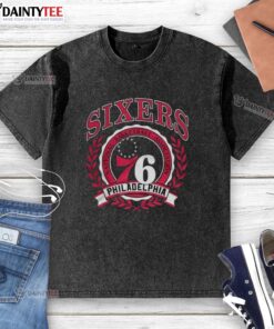 Retro washed t-shirt featuring the Philadelphia 76ers logo framed by a laurel wreath, perfect for NBA fans.