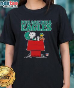 Alt Text: Awesome Philadelphia Eagles Snoopy chilling with football in Peanuts style on a ladies tee shirt design.
