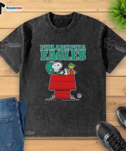 Awesome Philadelphia Eagles Snoopy chilling with a football in Peanuts style on a washed t-shirt design.