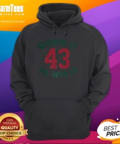 Quinn Hughes wearing a Minnesota Wild hoodie, 'Quinn It To Win It,' showcasing number 43 in an NHL game.