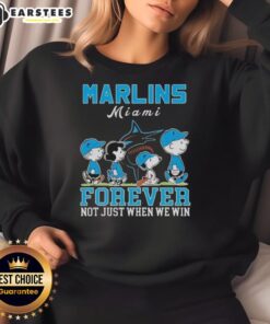 Alt Text: Awesome Snoopy and Charlie Brown Miami Marlins baseball sweatshirt, perfect for fans celebrating all seasons.