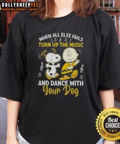 Alt Text: Snoopy and Charlie Brown dancing joyfully, showcasing the 'When All Else Fails, Turn Up The Music' tee for dog lovers.