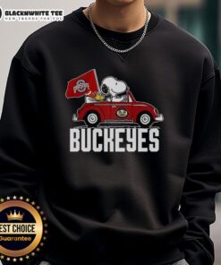Awesome Snoopy and Woodstock driving a car with Ohio State Buckeyes flag sweatshirt design for fans and gift ideas.