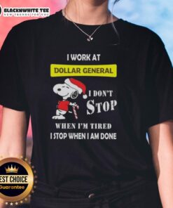 Alt Text: Awesome Snoopy Christmas tee for ladies: 'I Work At Dollar General, I Don't Stop When I'm Tired' design.