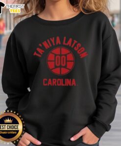 Taniya Latson poses in a stylish South Carolina basketball sweatshirt, showcasing team spirit and athletic fashion.