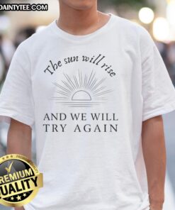 Awesome 'The Sun Will Rise And We Will Try Again' t-shirt design featuring a motivational quote on a soft fabric backdrop.