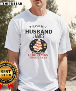 Alt Text: Awesome Trophy Husband James wearing a Christmas Tree Cakes t-shirt, celebrating the holiday spirit.