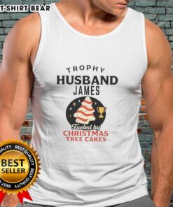 Awesome Trophy Husband James wearing a festive tank top, enjoying Christmas Tree Cakes, ready for holiday fun.