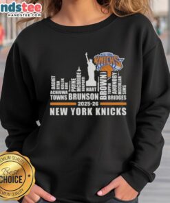 Alt Text: Cute 2025-26 New York Knicks basketball sweatshirt featuring city skyline design and player names for fans.