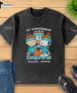 Alt Text: Cute Charlie Brown and Snoopy 61st Anniversary t-shirt featuring Miami Dolphins football skyline design, 1965-2026.