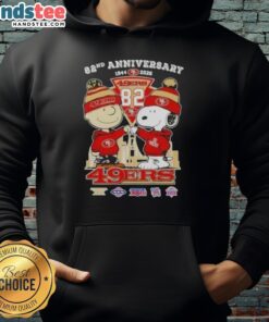 Alt Text: Cute Charlie Brown and Snoopy hoodie celebrating Super Bowl 82nd Anniversary with San Francisco 49ers skyline design.