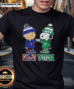 Alt Text: Cute Charlie Brown and Snoopy fist bump on Knicks X Jets t-shirt, perfect for New York City sports fans.