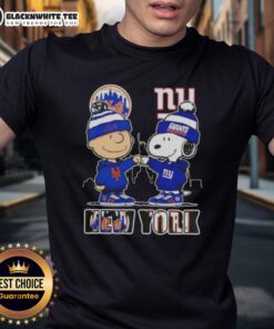 Alt Text: Cute Charlie Brown and Snoopy fist bump in NYC sports Mets vs Giants skyline graphic t-shirt design.