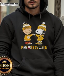 Alt Text: Cute Charlie Brown and Snoopy fist bump in Pittsburgh Steelers and Penguins hoodie, celebrating city sports spirit.