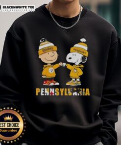 Alt Text: Cute Charlie Brown fist bump with Snoopy on Pittsburgh Steelers and Penguins sweatshirt in Pennsylvania city.