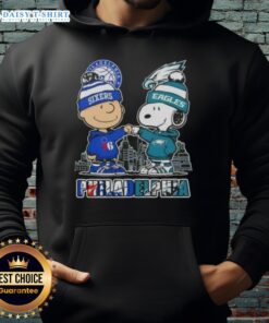 Alt Text: Cute Charlie Brown fist bump with Snoopy in Philadelphia skyline hoodie featuring 76ers and Eagles logos.