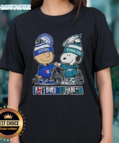Alt Text: Cute Charlie Brown fist bump with Snoopy, featuring Philadelphia skyline and 76ers, Eagles sports theme on ladies tee.