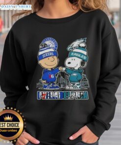 Adorable Charlie Brown fist bump with Snoopy on a Philadelphia skyline sweatshirt for 76ers and Eagles fans.