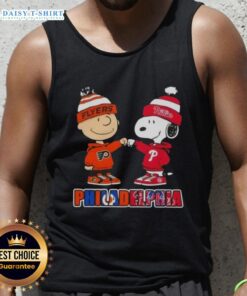 Alt Text: Cute Charlie Brown fist bump with Snoopy in Phillies and Flyers tank top, perfect for Philadelphia sports fans.