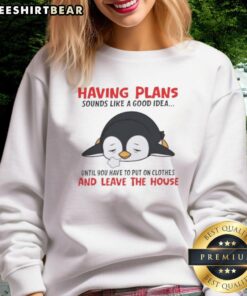 Cute penguin in a cozy sweatshirt, contemplating plans outsidea relatable moment for anyone who prefers staying in.