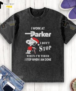 Cute Snoopy graphic on a Christmas T-shirt with 'I work at Parker Hannifin, I don't stop when I'm tired' slogan.