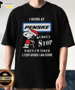 Alt Text: Cute Snoopy Christmas T-shirt featuring the phrase I work at Penske Corporation, I don't stop when I'm tired.