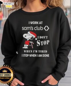 Cute Snoopy Christmas sweatshirt with text: 'I work at Sam's Club, I don't stop when I'm tired, I stop when I'm done.'