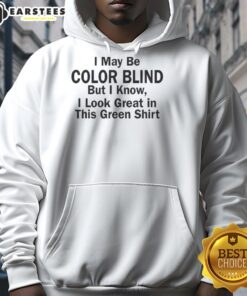 Person wearing a green hoodie with a humorous quote about color blindness, showcasing a playful style and vibrant color.