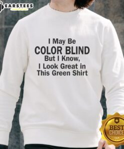 Man wearing a green sweatshirt humorously claiming color blindness, showcasing his vibrant green outfit.