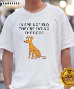 Alt Text: Funny In Springfield They're Eating The Dogs T-Shirt featuring a humorous cartoon dog design and vibrant colors.