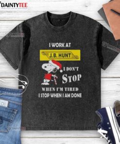 Funny Snoopy Christmas t-shirt featuring 'I work at J.B. Hunt, I don't stop when I'm tired, I stop when I'm done' slogan.