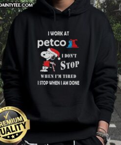 Funny Snoopy Christmas hoodie with text: 'I work at Petco, I don't stop when I'm tired, I stop when I'm done.'