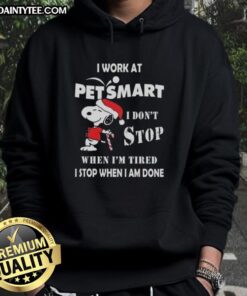 Alt Text: Funny Snoopy Christmas hoodie with I work at PetSmart, I don't stop when I'm tired, I stop when I'm done quote.