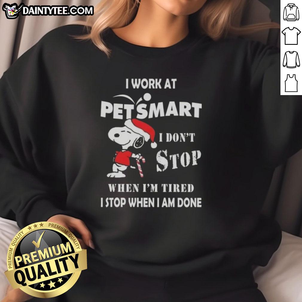 funny-snoopy-i-work-at-petsmart-i-dont-stop-when-im-tired-i-stop-when-i-am-done-christmas-sweatshirt Funny Snoopy Christmas sweatshirt featuring the phrase 'I work at PetSmart, I dont stop when Im tired'.