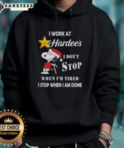 Funny Snoopy Christmas hoodie with 'I work at Hardee's, I don't stop when I'm tired, I stop when I'm done' slogan.