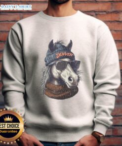 Denver Broncos mascot wearing a beanie and sunglasses, showcasing team spirit in a cozy sweatshirt.