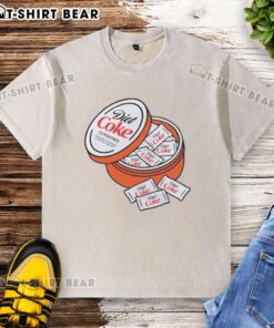 Good Diet Coke Zyn pouches displayed on a washed t-shirt, showcasing a casual style and lifestyle accessory.