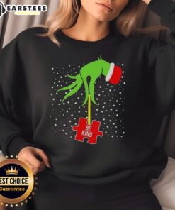 Alt Text: Good Grinch Hand Be Kind Puzzle Autism Awareness Christmas Sweatshirt featuring festive design and vibrant colors.