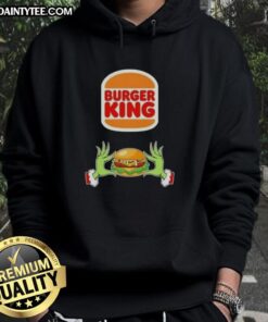 Alt Text: Good Grinch Hands holding a Burger King meal, wearing a Merry Christmas hoodie, festive holiday spirit.
