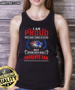 Alt Text: New England Patriots fan wearing a tank top that says 'Good I Am Proud Of Many Things In Life' at a game.