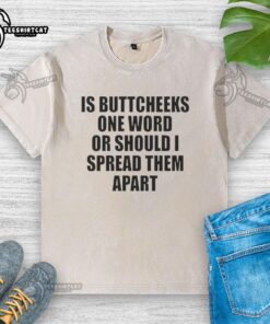 Good Is Buttcheeks washed t-shirt design featuring playful text, perfect for casual wear and humor enthusiasts.