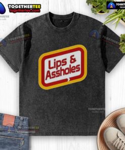 Good Lips and Assholes Washed T-Shirt displayed on a hanger, showcasing its unique graphic design and soft fabric.