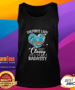 Alt Text: Stylish woman wearing a Miami Dolphins tank top with Sassy, Classy, and a Tad Badassy design, showcasing team spirit.